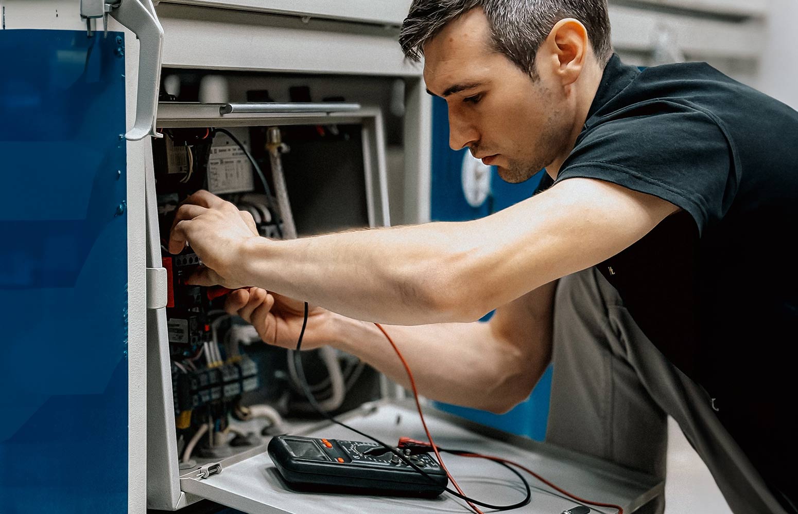 Electrician wiring a consumer unit